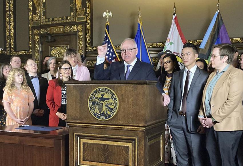 Minnesota Gov. Tim Walz speaks at a signing ceremony — Photo by Steve Karnowski / AP